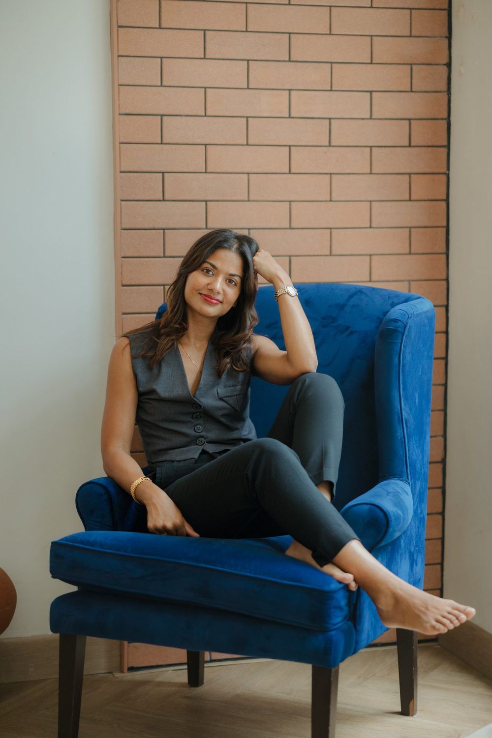 Sonia Louis, schema therapist, sitting in a blue armchair